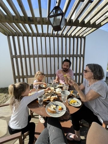 A multi-generation family meal under the pergola