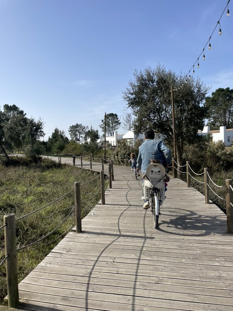 Family biking on the boardwalk paths