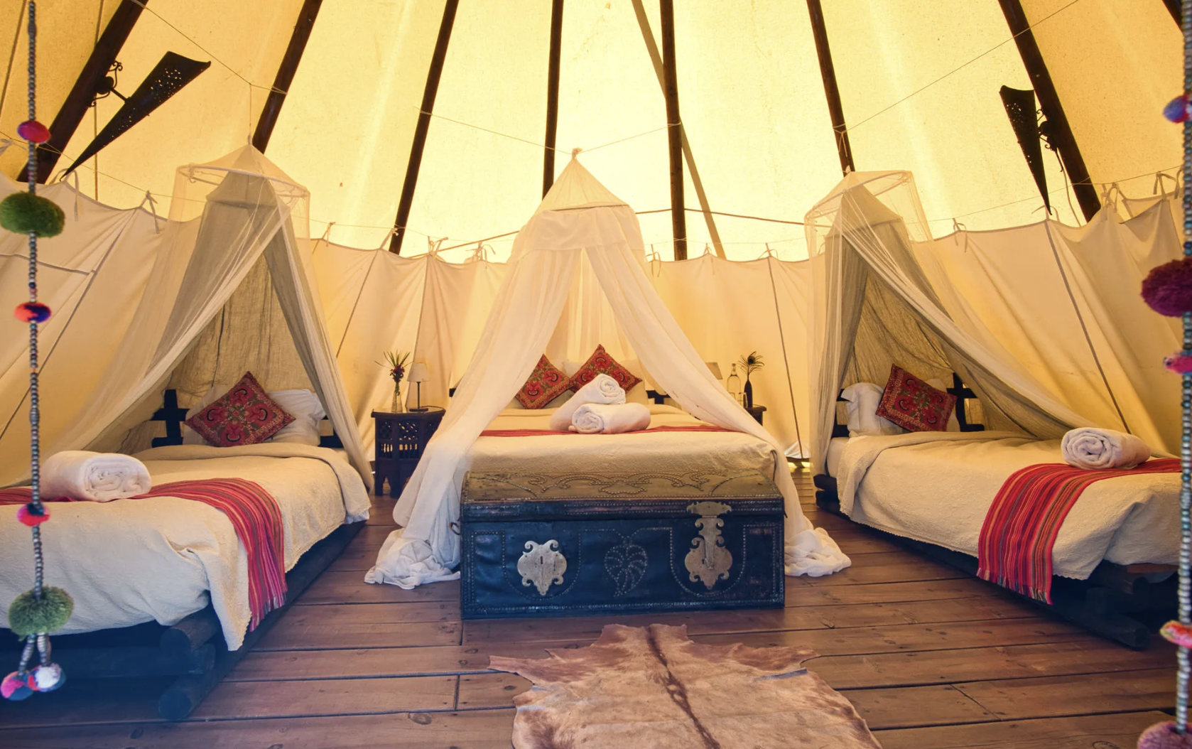 Sunshine tipi interior with three beds