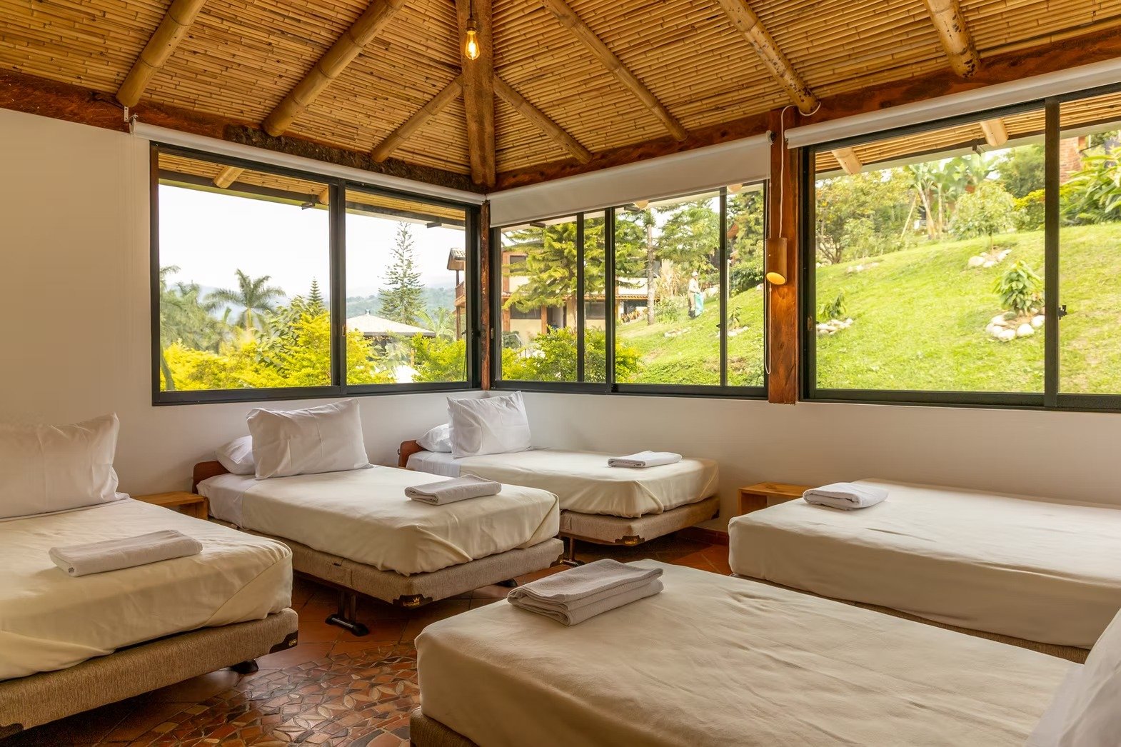 Bright multi-bed room with bamboo ceiling and panoramic windows at Casa Sumapaz