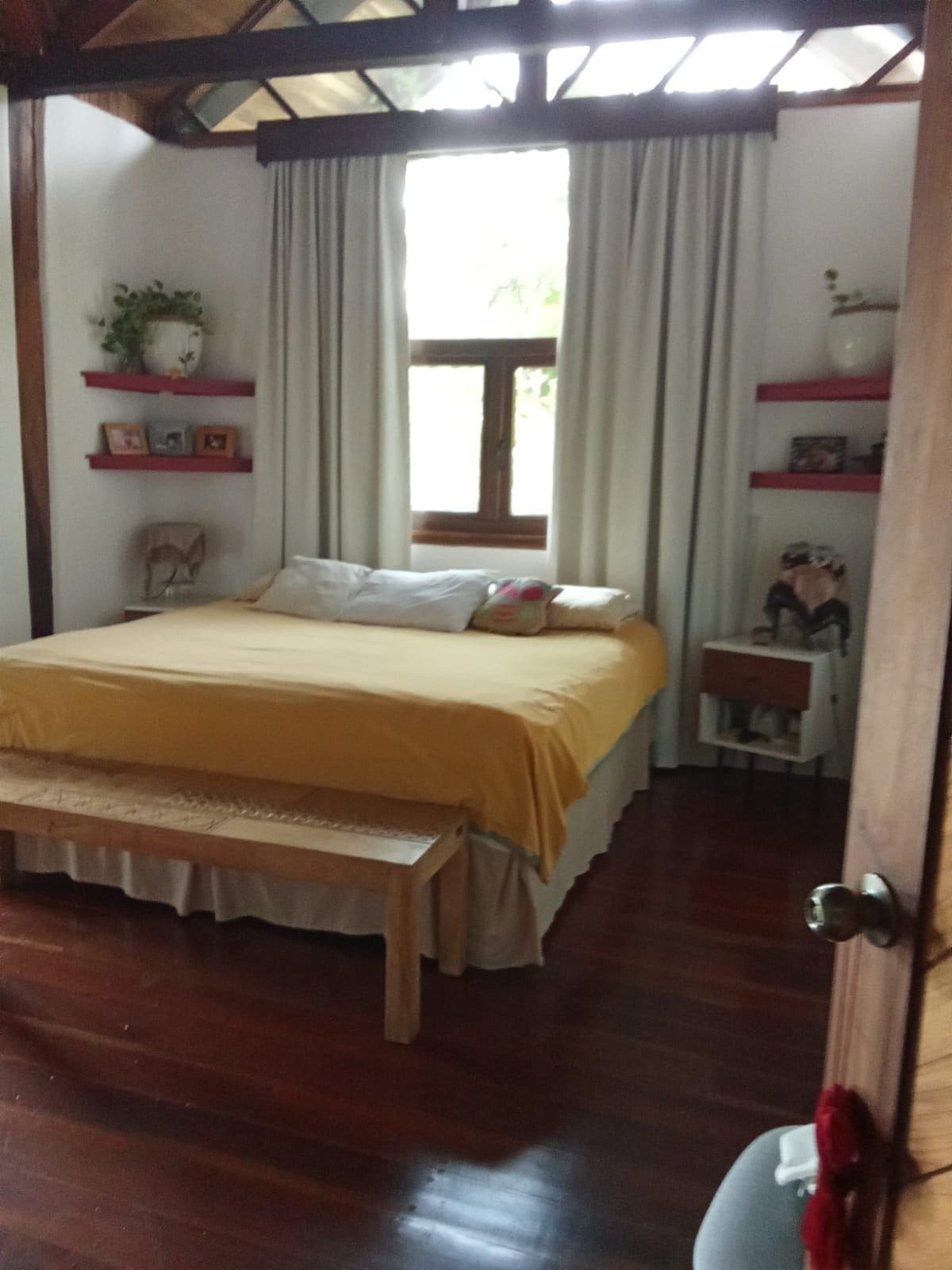 Casa Brisa bedroom with king bed and red shelves