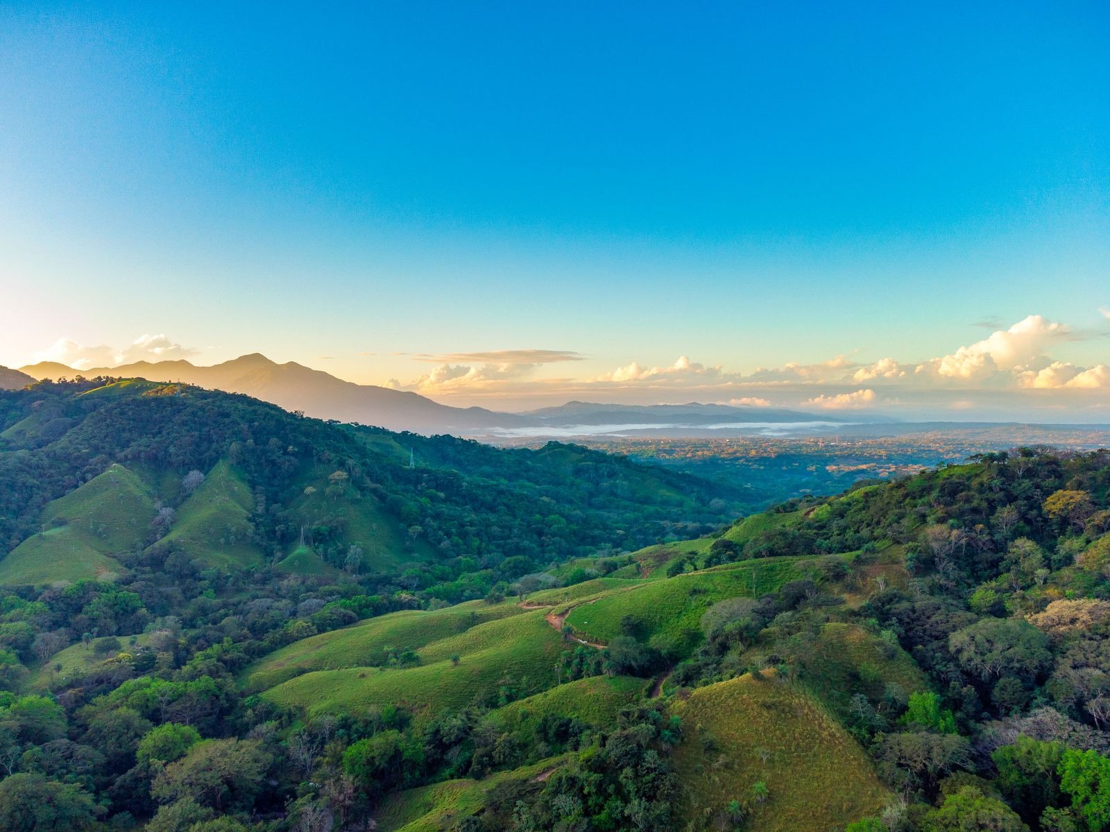 Sunrise over green Costa Rican mountains seen from Pura Maracuya