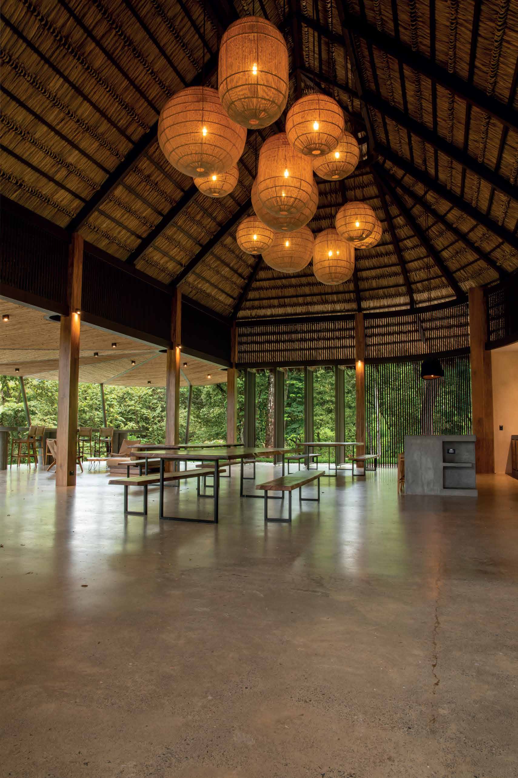 The rancho gathering space with long wooden tables and hanging lanterns